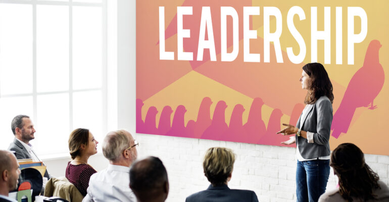 Facilitator presenting to leaders during a workshop on leading in complexity using the Four Factor Model.