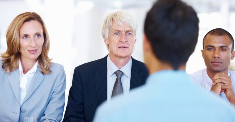 Interview panel assessing candidate fit and interview skills